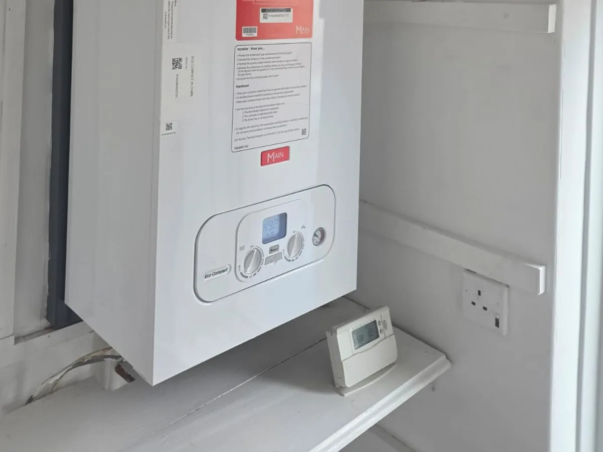 Serviced combi boiler with its controls and wall-mounted programmer
