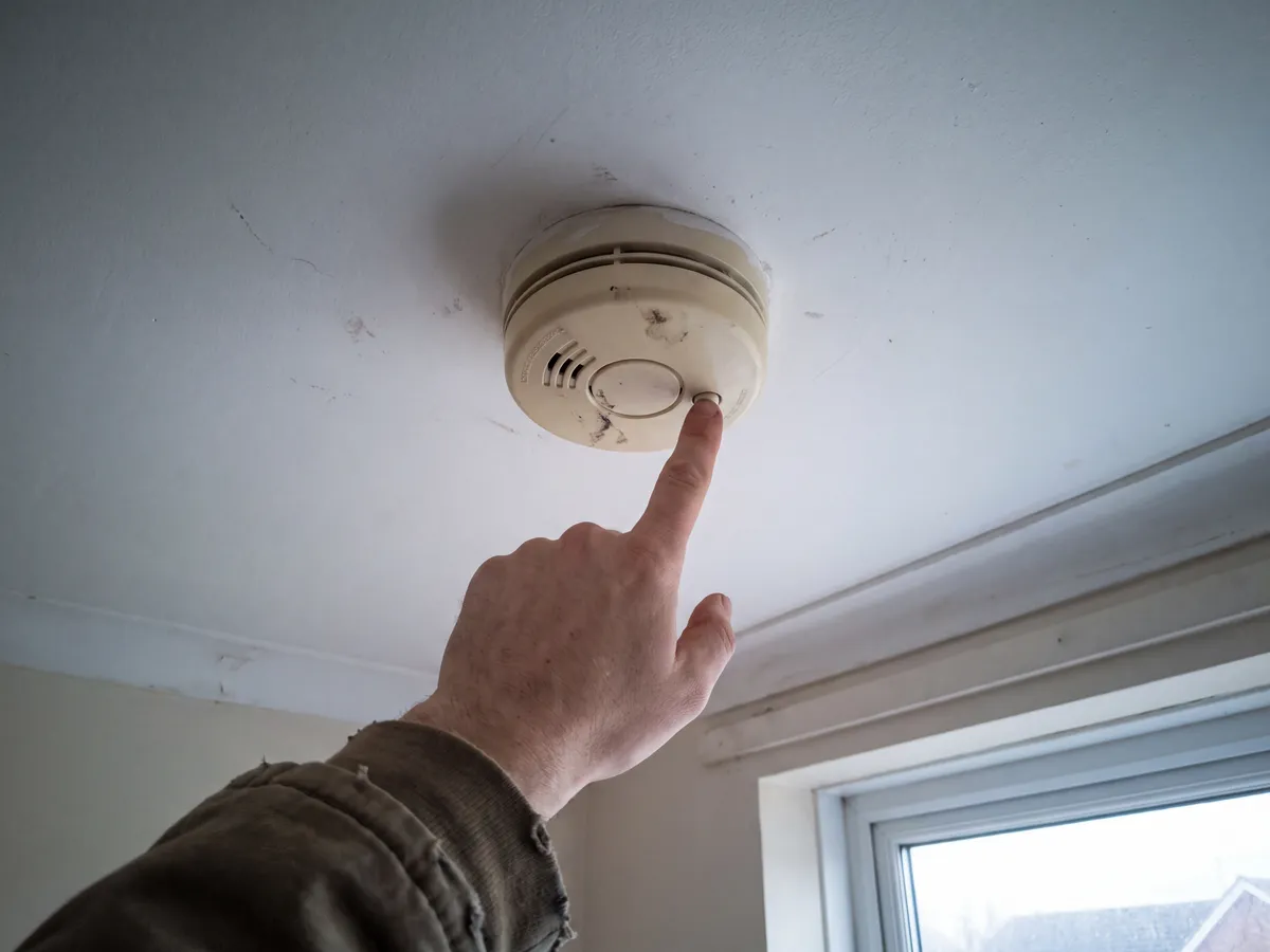 Mains-wired smoke alarm being tested